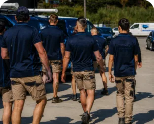 Plumbers walking to their service vans on a Parramatta job